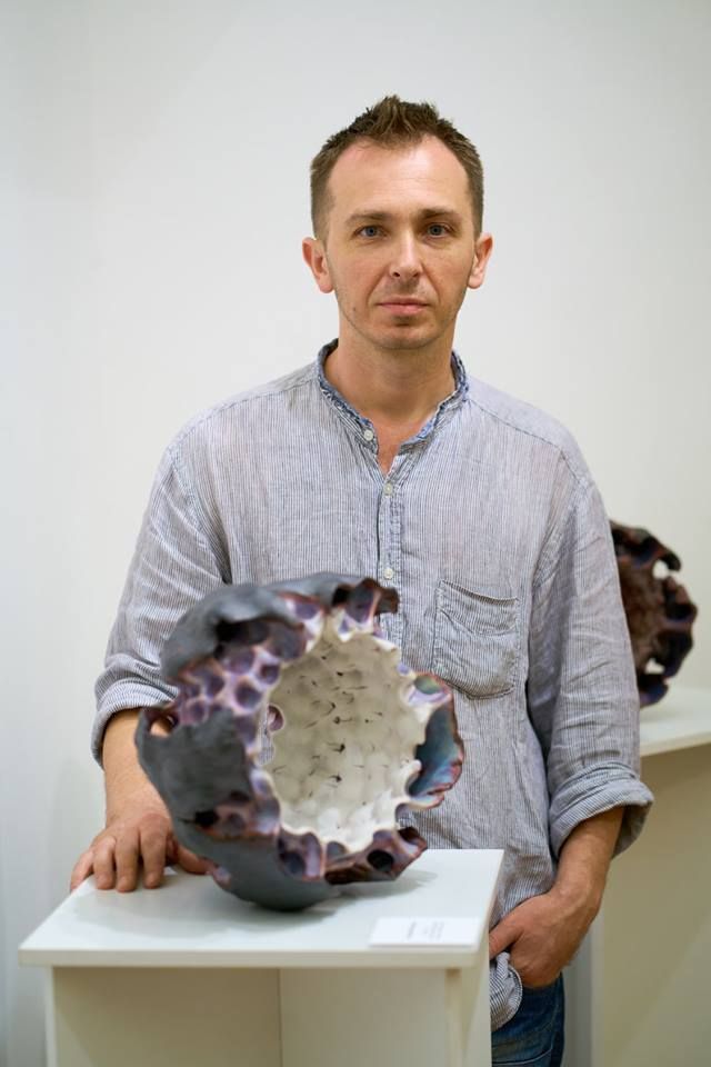 Andriy Kyrychenko with ceramic sculpture from the Shell series